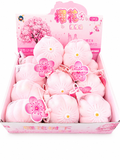 Squishy Sakura fleur de cerisier kawaii dans son filet blanc avec pendentif
