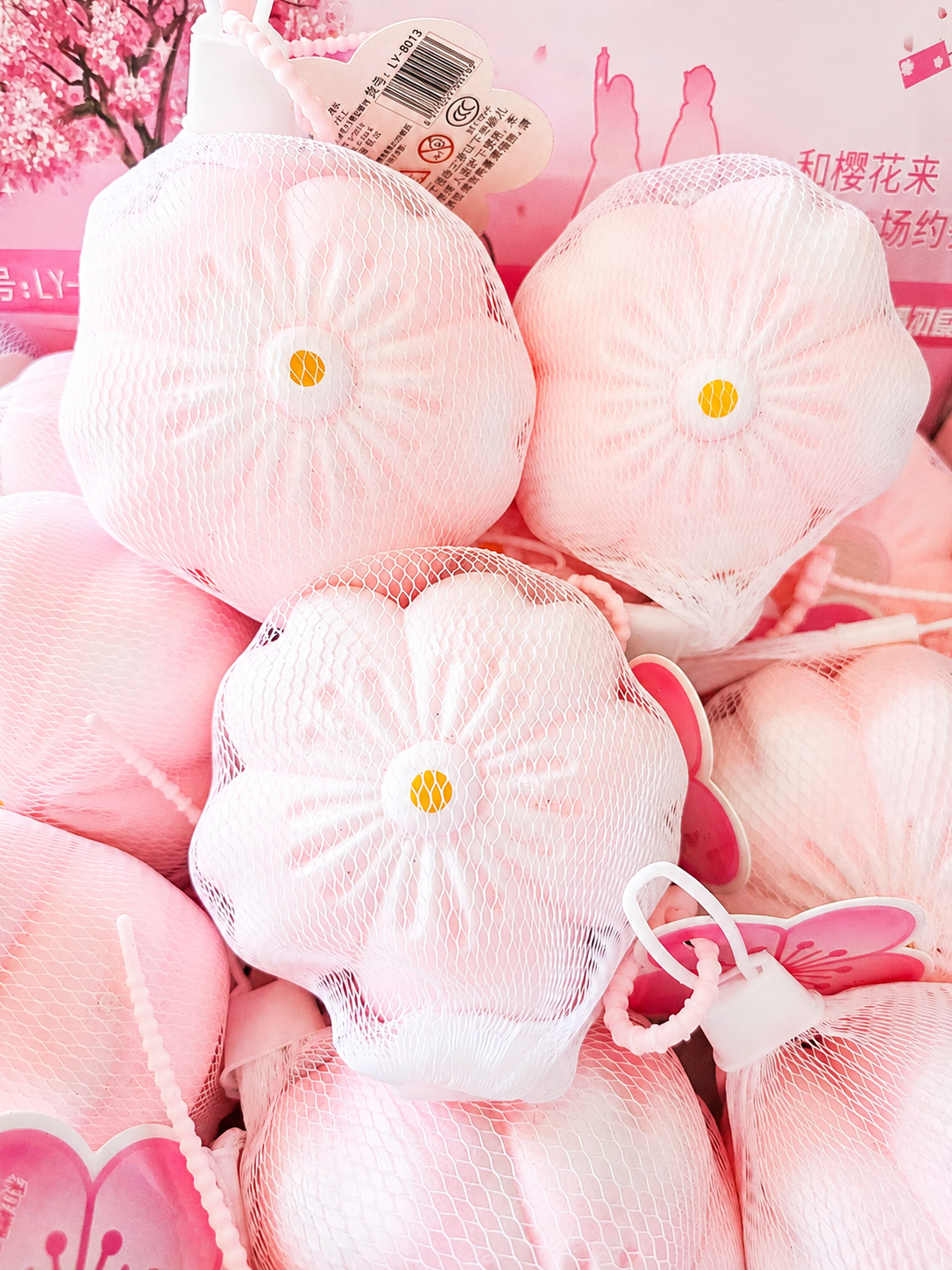 Squishy Sakura fleur de cerisier tenu en main, vue de profil
